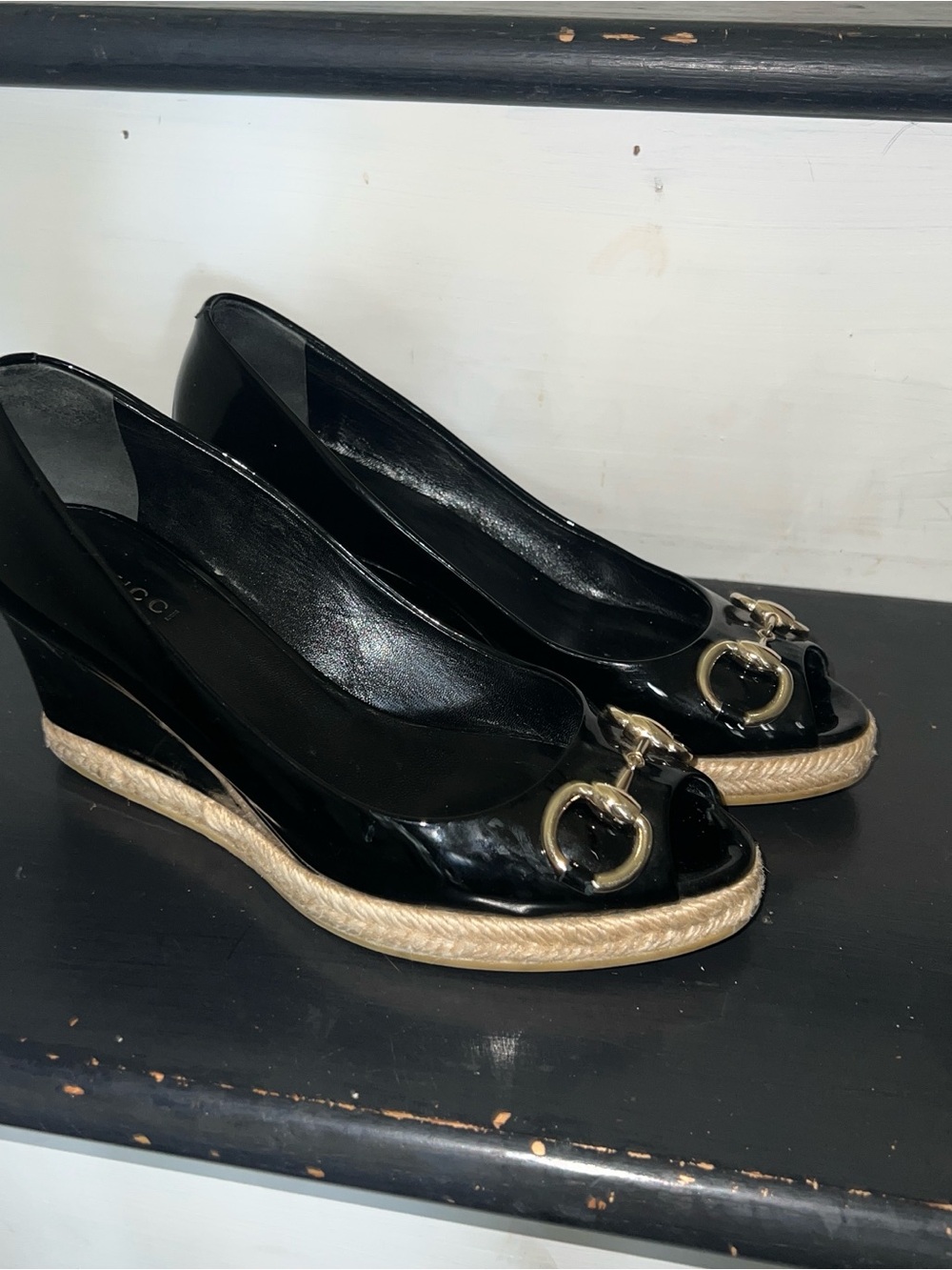 Black patent leather Gucci wedges with horsebit and peep toe